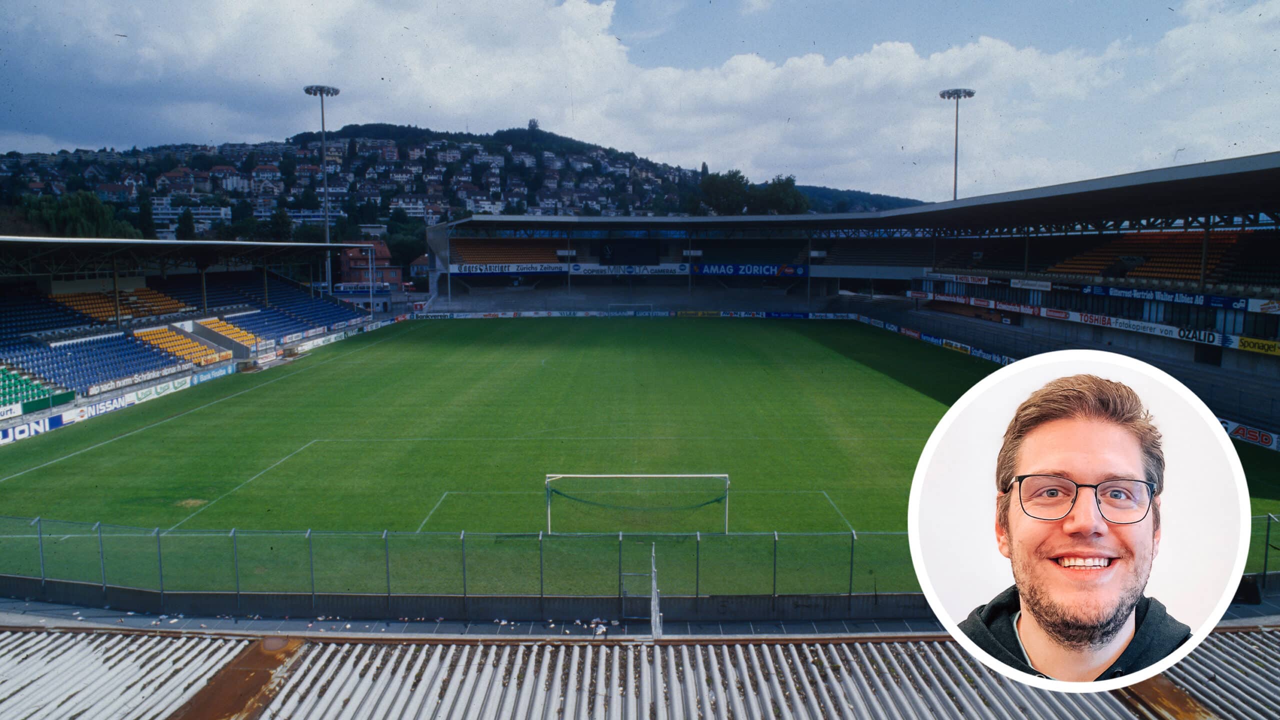 Das in die Jahre gekommene, leere Hardturm-Stadion im Jahr 1987. Der Himmel ist leicht Wolke verhangen, aber der Stadionrasen leuchtet sattgrün.