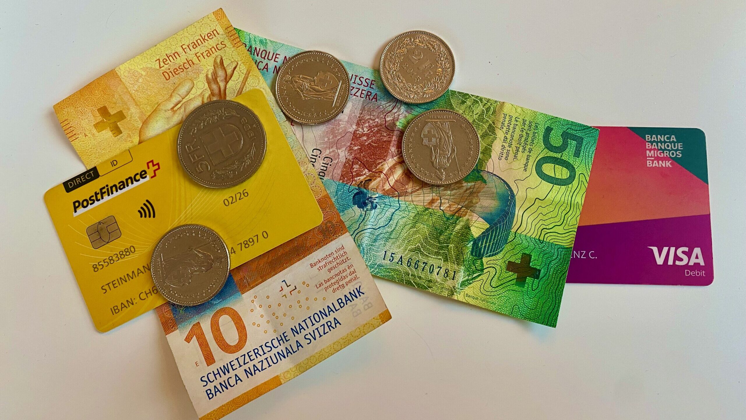 Auf dem Bild zu sehen sind Bargeld und zwei Bezahlkarten.