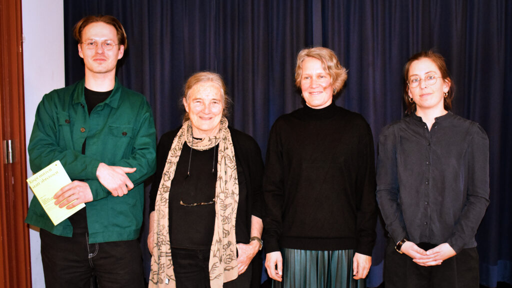 Ein Mann und drei Frauen haben für ein Gruppenbild aufgestellt.